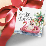 Santa Beach Merry Christmas Favour Tags<br><div class="desc">Celebrate the season with this festive and playful favour tag, perfect for adding to Christmas gifts, party favours, and more. The design features a laid-back Santa in sunglasses lounging in a pink flamingo floaty, surrounded by ocean waves and tropical vibes—bringing a fun twist to your coastal holiday celebration. "Merry Christmas"...</div>