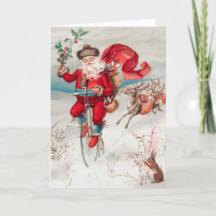 Santa Claus Riding Bicycle, Reindeer and Rabbit Holiday Card