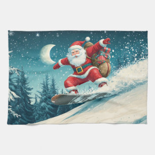 Santa delivering Christmas presents on a snowboard Kitchen Towel