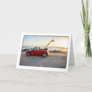 Santa driving Mini at the beach with a SUP Holiday Card