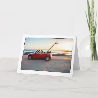 Santa driving Mini at the beach with a SUP Holiday Card