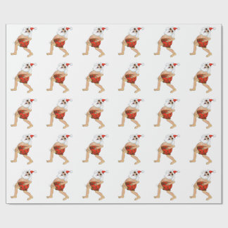 Santa frolicking in swimming trunks. wrapping paper