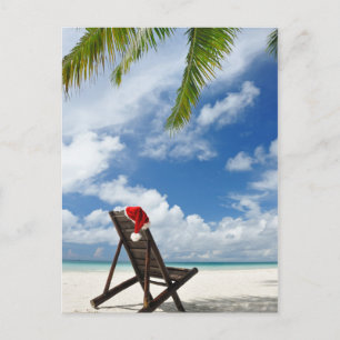 Santa's hat and chaise lounge on the beach holiday postcard