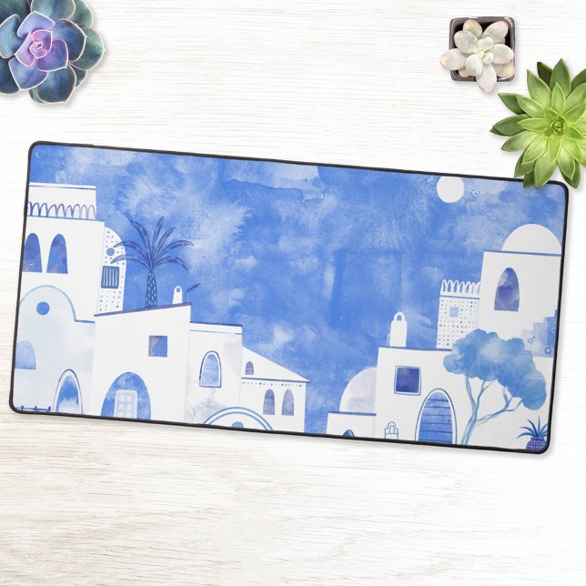 Santorini Greece Watercolor Blue White Desk Mat (Desk mat featuring a blue and white watercolor painting of Oia on the Greek island of Santorini.)