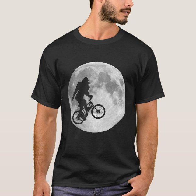 Sasquatch Bigfoot on Bike in Sky with Moon T-Shirt (Front)