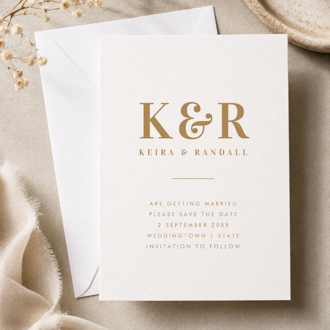 Save The Date | Gold Monogram Wedding Announcement (Gold monogram save the date card with couple initials, names, date, and location details.)