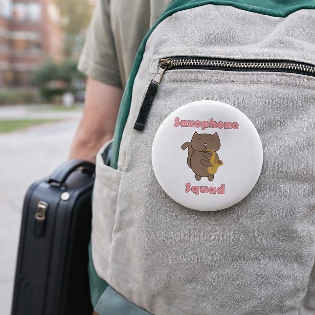 Saxophone Squad Cute Kawaii Cat Pink 2 Inch Round Button (A pin featuring a brown cat playing saxophone and the words saxophone squad in pink.)