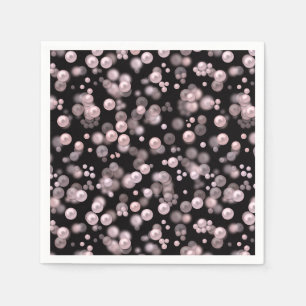 Scatterings of pink and white pearls on black velv napkin