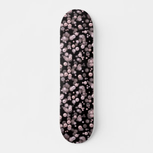Scatterings of pink and white pearls on black velv skateboard