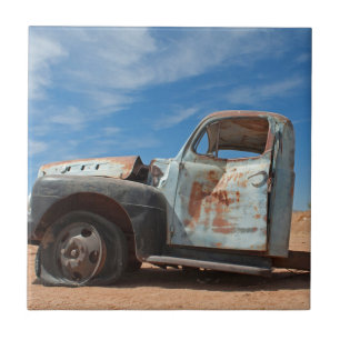 Scrap car in the desert tile
