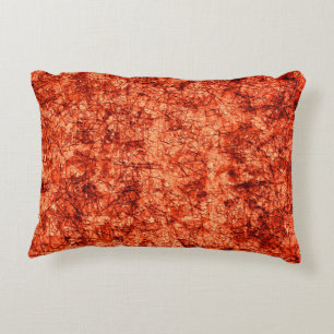 Scratches on scratches on a lightly spotted coral accent pillow