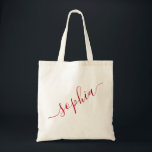 Script Name Red Personalized Modern Simple Tote Bag<br><div class="desc">Chic red personalized labelled reusable canvas tote bag with custom name text for bridesmaid gifts, bachelorette parties, birthday favours, and girls trip keepsakes, and graduation gift for cute college and dorm room storage. Perfect for sports and hobby gear storage and transport. Colours and fonts are editable, just click “customize further”...</div>