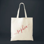 Script Name Red Personalized Modern Simple Tote Bag<br><div class="desc">Chic red personalized labelled reusable canvas tote bag with custom name text for bridesmaid gifts, bachelorette parties, birthday favours, and girls trip keepsakes, and graduation gift for cute college and dorm room storage. Perfect for sports and hobby gear storage and transport. Colours and fonts are editable, just click “customize further”...</div>