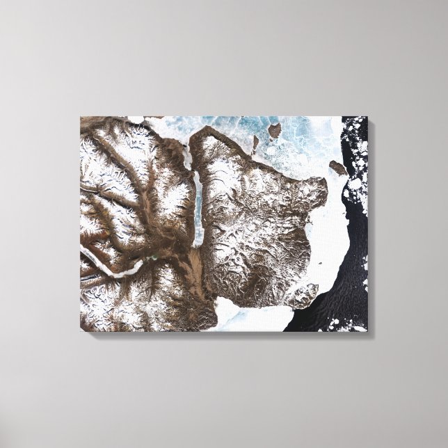 Sea ice lines the shoreline in eastern Greenlan Canvas Print (Front)