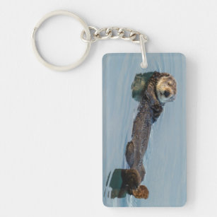 Sea otter floating on back in ocean keychain
