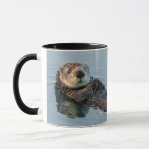 Sea otter floating on back in ocean mug