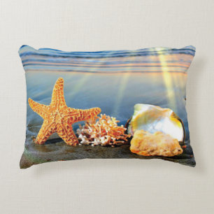 Sea shells and starfish on beach accent pillow