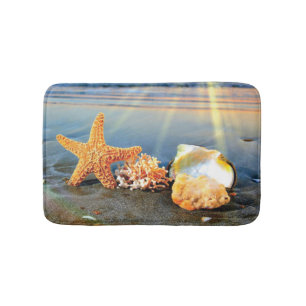 Sea shells and starfish on beach bath mat