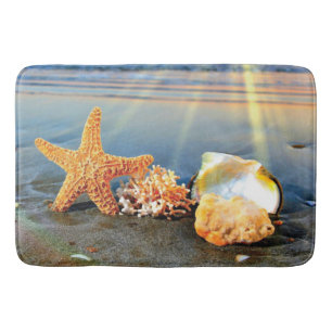 Sea shells and starfish on beach bath mat
