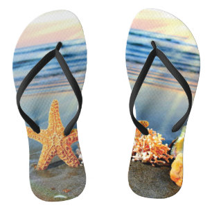 Sea shells and starfish on beach flip flops