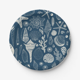 Sea shells on  dark blue paper plate