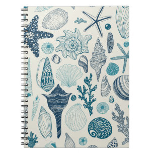 Sea shells on  off white notebook