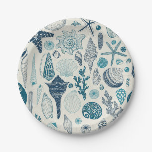 Sea shells on off white paper plate