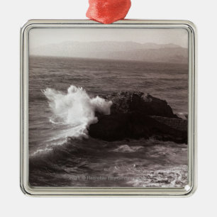 Sea waves crashing against rock metal ornament