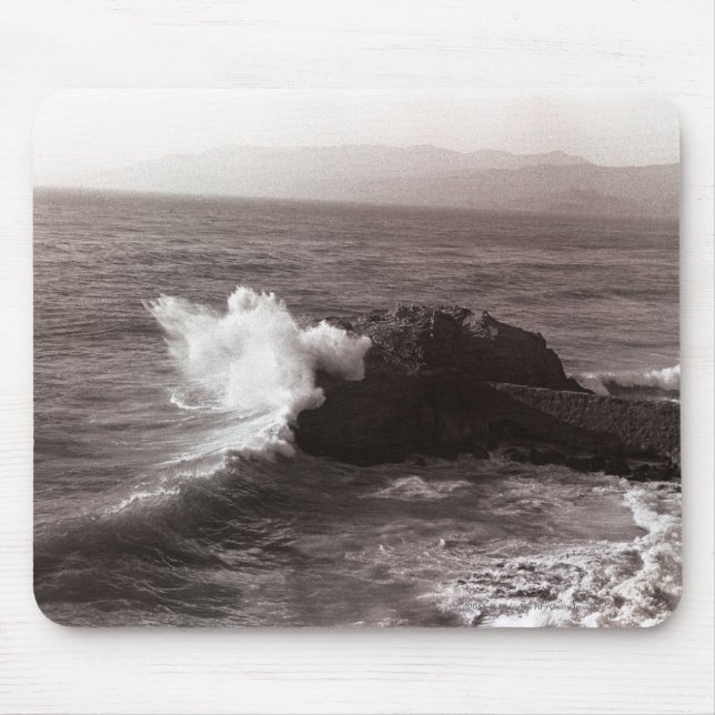 Sea waves crashing against rock mouse pad (Front)