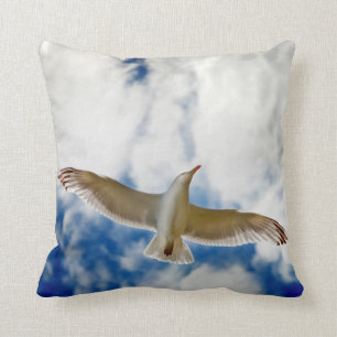 Seagul in flight with blue skies and white cloud, throw pillow