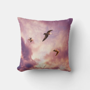 Seagulls flying in a sunset sky throw pillow