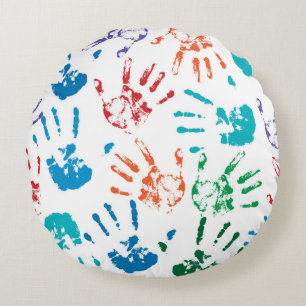 Seamless pattern of multicolored human hands on a  round pillow