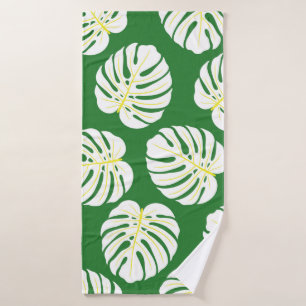 Seamless pattern of white monstera leaves on a dar bath towel