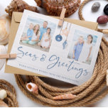 Seas and Greetings Coastal Wood Holiday Photo<br><div class="desc">Seas and Greetings Seashell Ornament on Coastal Wood Holiday Photo Christmas Cards featuring ocean navy blue and sandy tan shell ornaments hanging from sailing jute rope on coastal shiplap wood with elegant typography. Add two of your photos and a personal message for a fun nautical holiday card. Please contact us...</div>