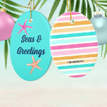 Seas & Greetings Starfish Retro Coastal Christmas Ceramic Ornament<br><div class="desc">Add a vibrant splash of coastal charm to your Christmas with this 'Seas & Greetings Starfish' Christmas ornament. This eye-catching ornament captures the whimsical spirit of the holiday season and a fun beach vibe all in one. The design features pink and coral starfish and a retro font over tropical turquoise...</div>