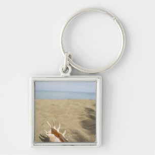 Seashell on sandy beach keychain