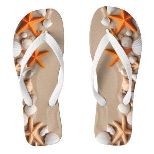 Seashells, starfish, and pebbles on a sandy beach  flip flops
