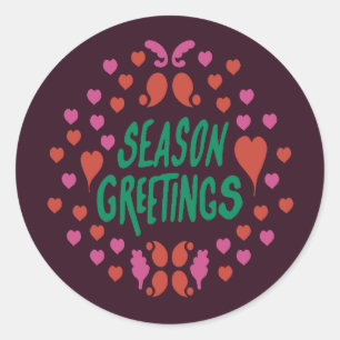 Season greetings in green handwriting with hearts classic round sticker