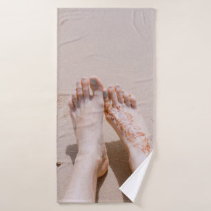 Selective focus photography of feet with tattoo on bath towel