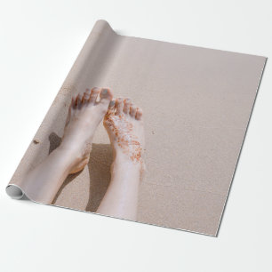 Selective focus photography of feet with tattoo on wrapping paper