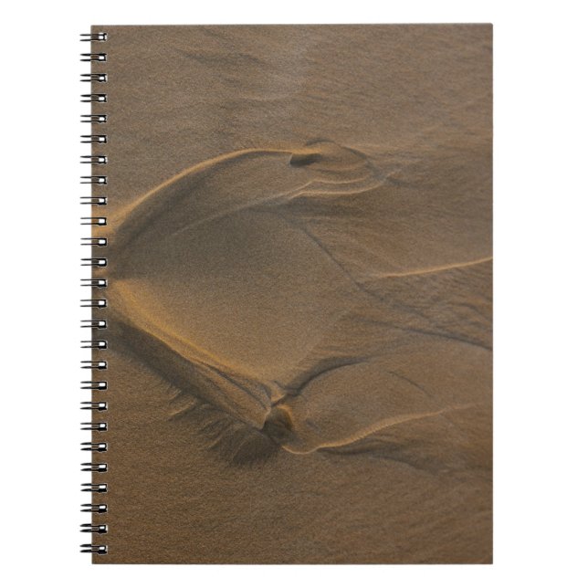 Selective focus photography of sand notebook (Front)