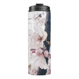 SELECTIVE FOCUS PHOTOGRAPHY OF WHITE AND PINK PETA THERMAL TUMBLER