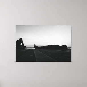 Serene Sunset Silhouettes on Coastal Boardwalk Canvas Print