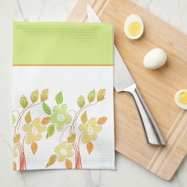 Serviette de cuisine orangée et verte à motifs flo (Quart Plié)