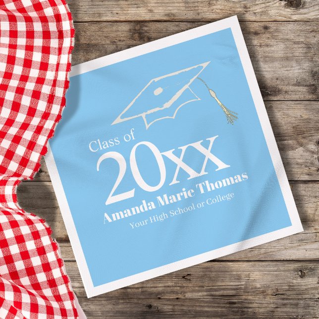 Serviette En Papier Light Blue Graduation Cap Class of 20XX Name (Light blue graduation napkin with Class of 20XX, custom name and cap design on table.)