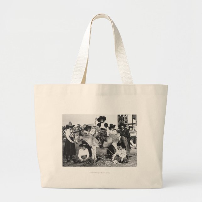 Seven rodeo cowgirls jokingly posing with a donkey large tote bag (Front)