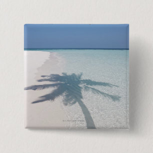 Shadow of a palm tree on a deserted island beach 2 inch square button