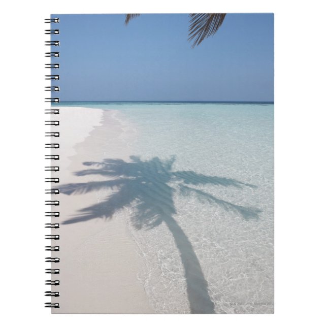 Shadow of a palm tree on a deserted island beach notebook (Front)