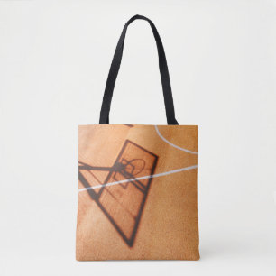 Shadow of basketball hoop tote bag
