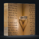 Shadow of Love Binder<br><div class="desc">Wedding ring creating a heart shadow on old Bible.</div>